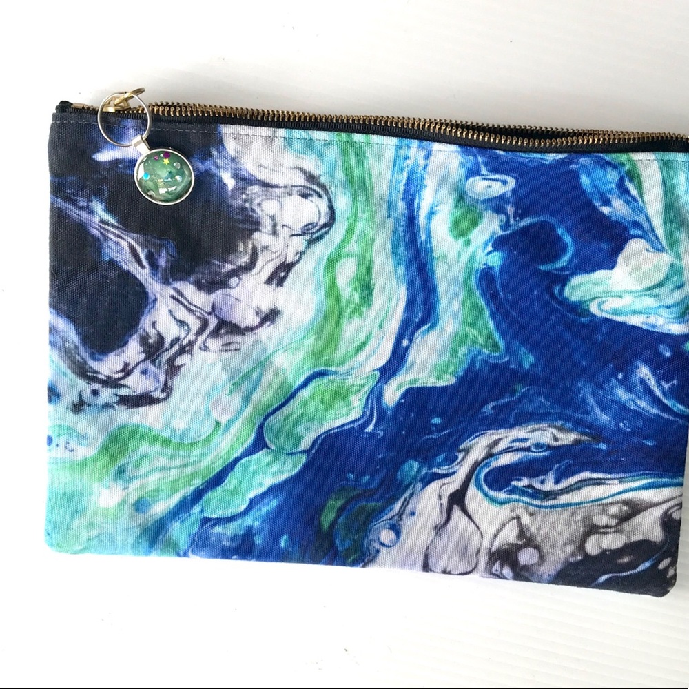 Zippered pouch with handmade pull and artwork design